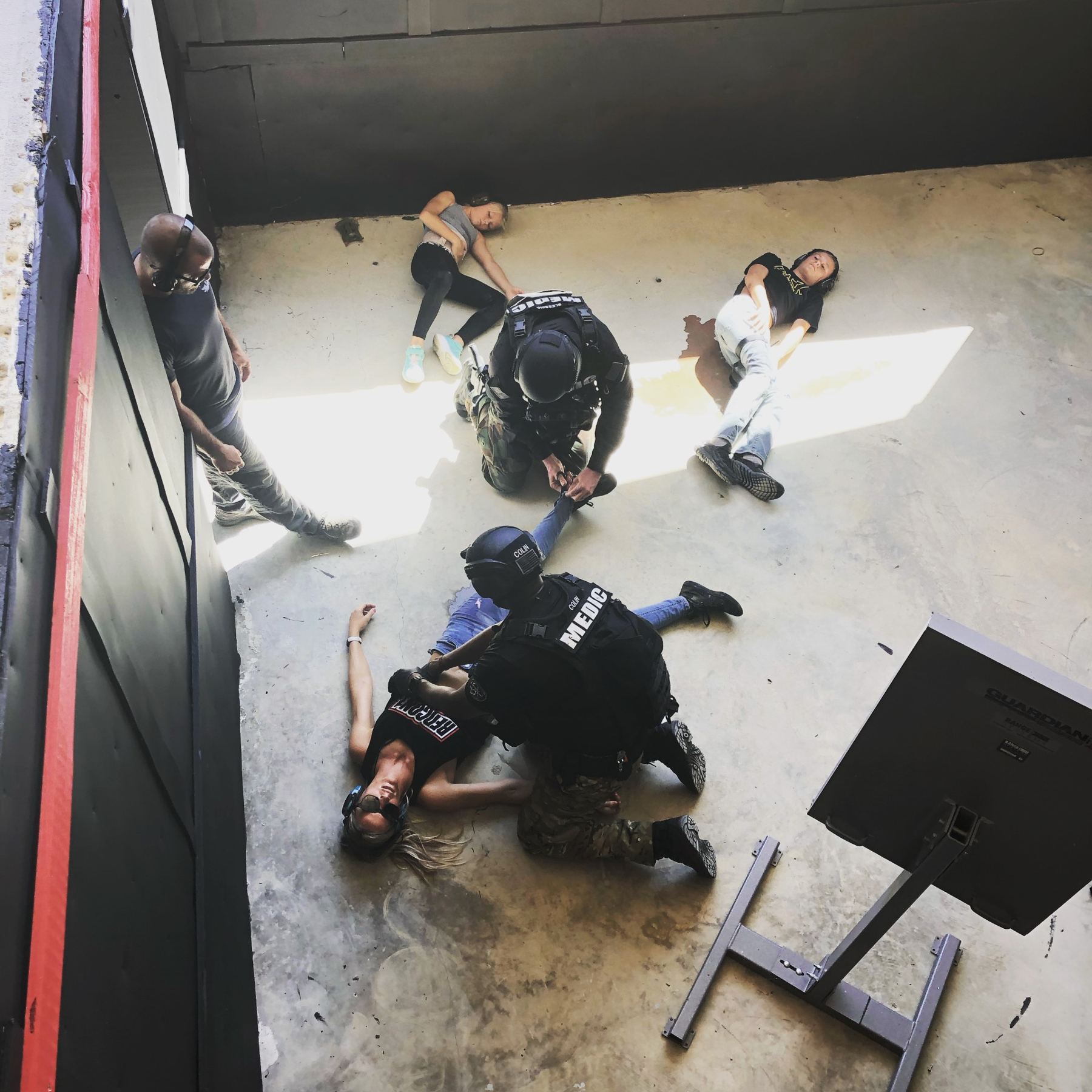 Medics treating role players inside the shoot house